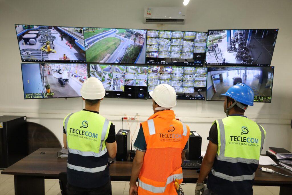 Trois techniciens Teclecom en salle de supervision devant des écrans de vidéosurveillance.